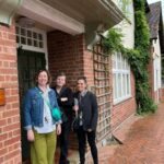 Three women stood outside the Moor Pool Estate Office