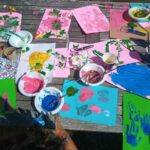 A wooden table covered in painted pictures