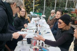 People sat around a table using botanical inks